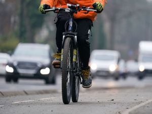 A woman rides a bike in a cycle lane