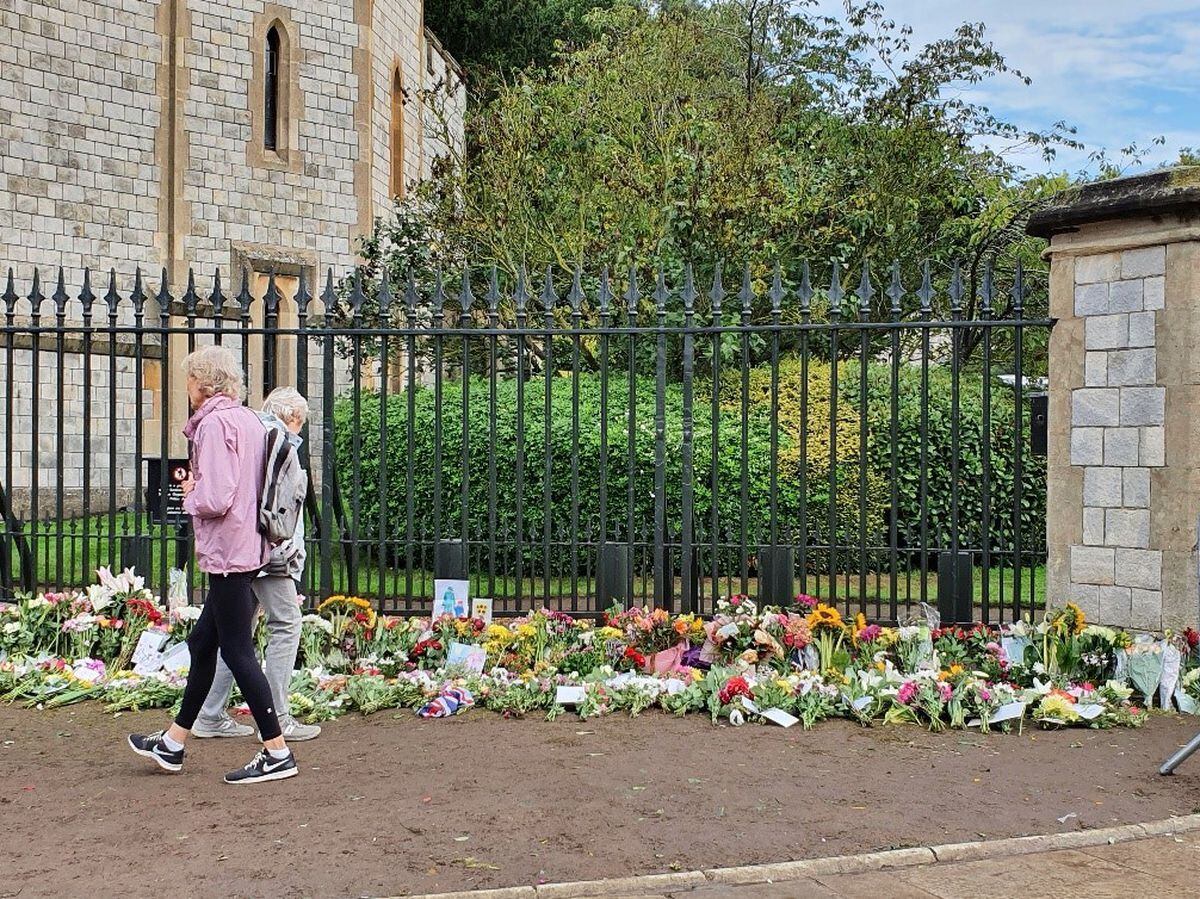 Flowers laid outside Windsor Castle in tribute to the late Queen. Photo: Dawn Hughes