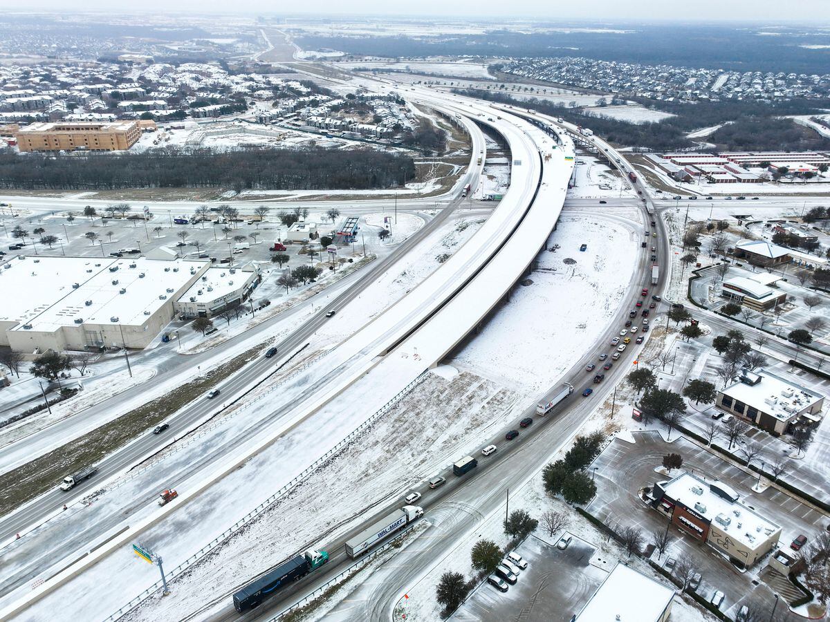 An icy mix covers Highway 114 in Roanoke, Texas