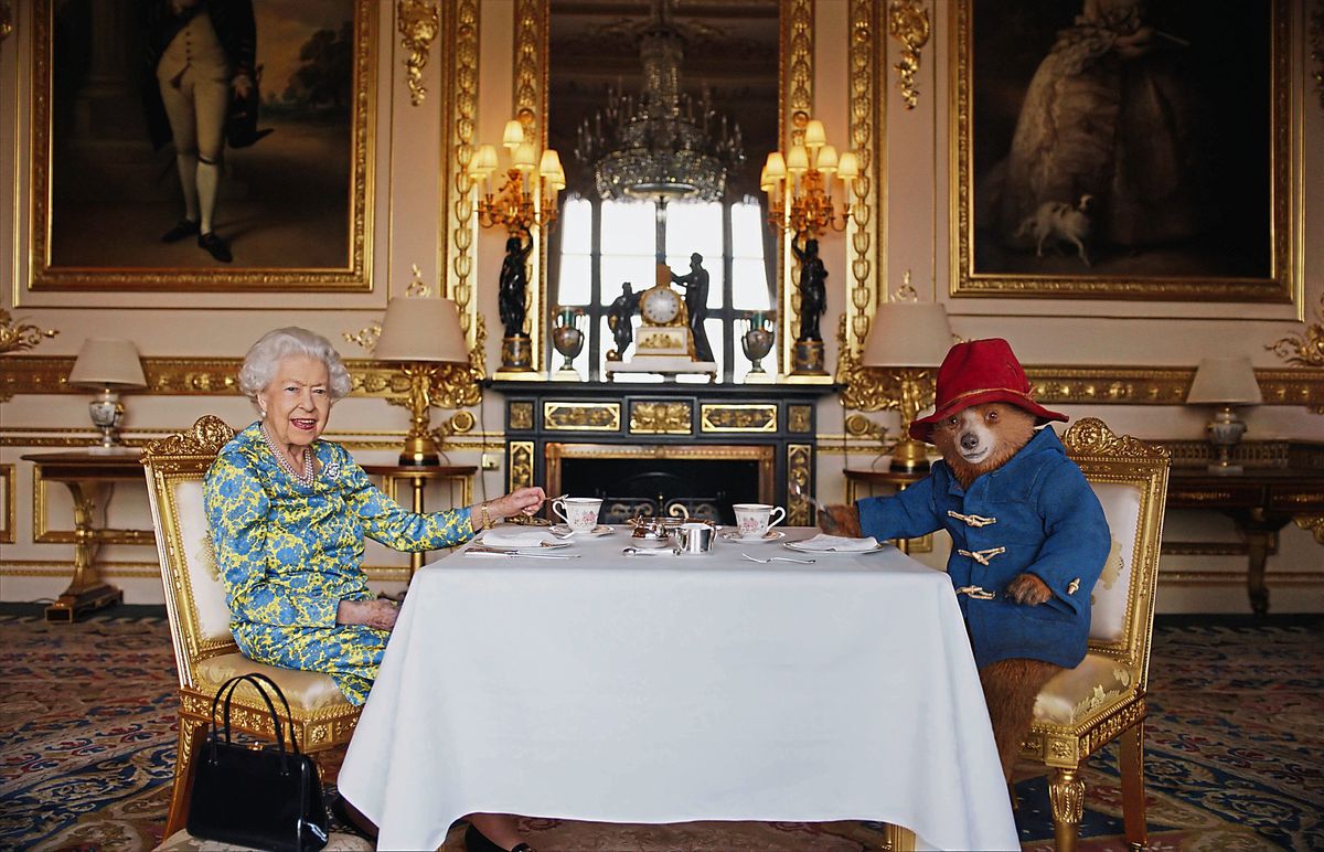 Queen Elizabeth II and Paddington Bear having cream tea for a film that was shown at the BBC Platinum Party at the Palace