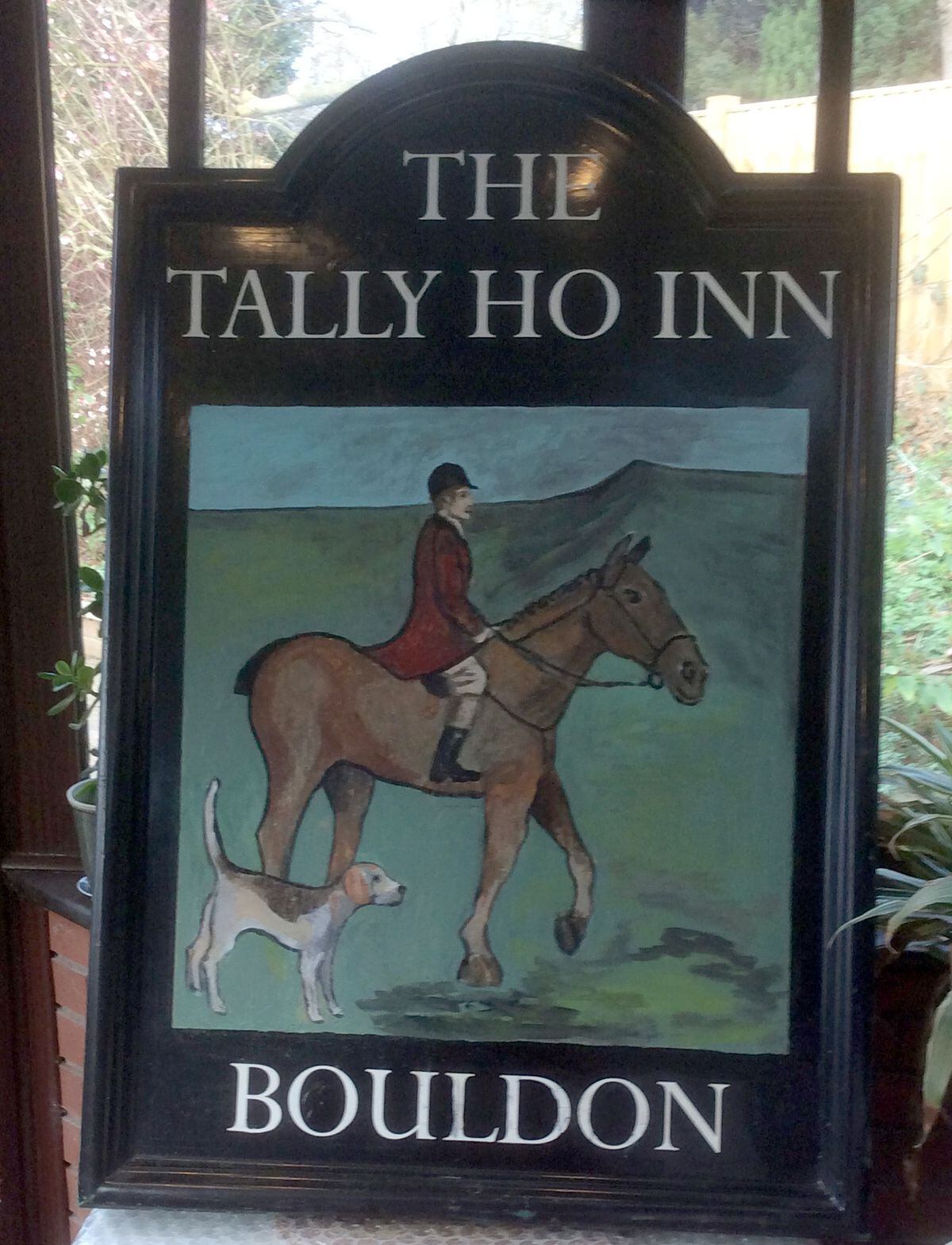 The restored pub sign awaits rehanging.