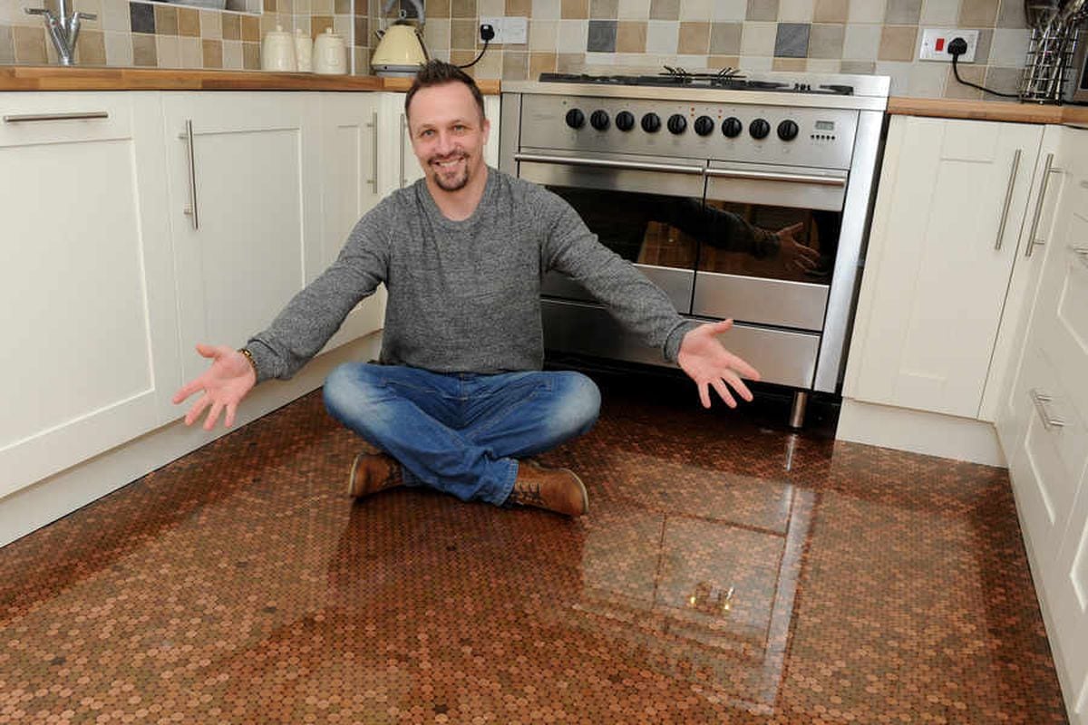 Matt Giles in his kitchen where he installed the penny floor