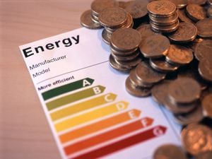 concept image of an appliance energy efficience rating label and a pile of uk money. 