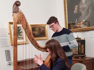 Award-winning harpist Gareth Swindail-Parry gives Bargain Hunt presenter Natasha Raskin-Sharp a lesson on how to play the Welsh Triple Harp at the Radnorshire Museum.