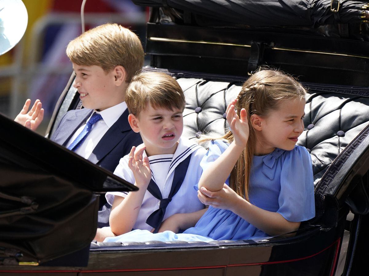 Prince George, Prince Louis and Princess Charlotte wave to crowds as they ride in a carriage during the Queen's Platinum Jubilee celebrations in 2022