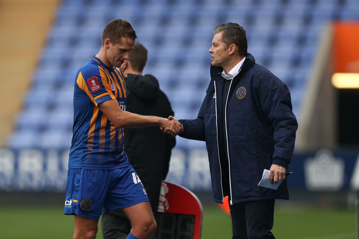 David Edwards of Shrewsbury Town shakes hands with Steve Cotterill the head coach / manager of Shrewsbury Town as he goes off injured. (AMA)