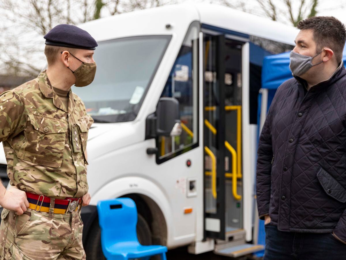 Councillor Shaun Davies speaking to one of the army volunteers helping out with the vaccination bus