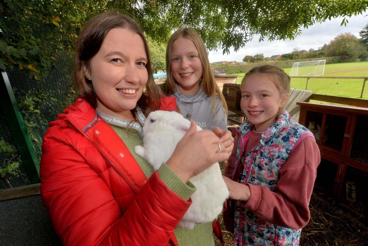 Marie Highfield with Hoppy the rabbit and Scarlett Highfield, 13, and Ava Highfield, 11