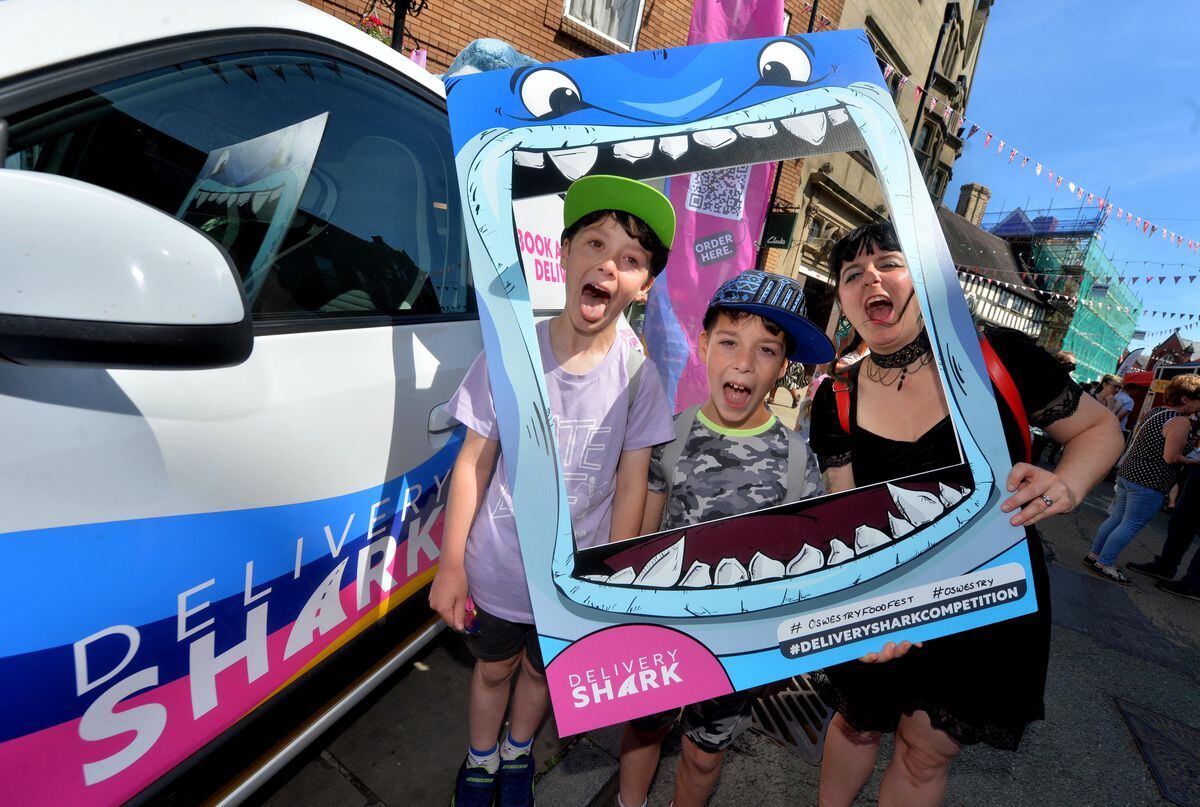 Having fun with the Delivery Shark selfie board is Aimee Bragg with Oliver and Noah Bragg