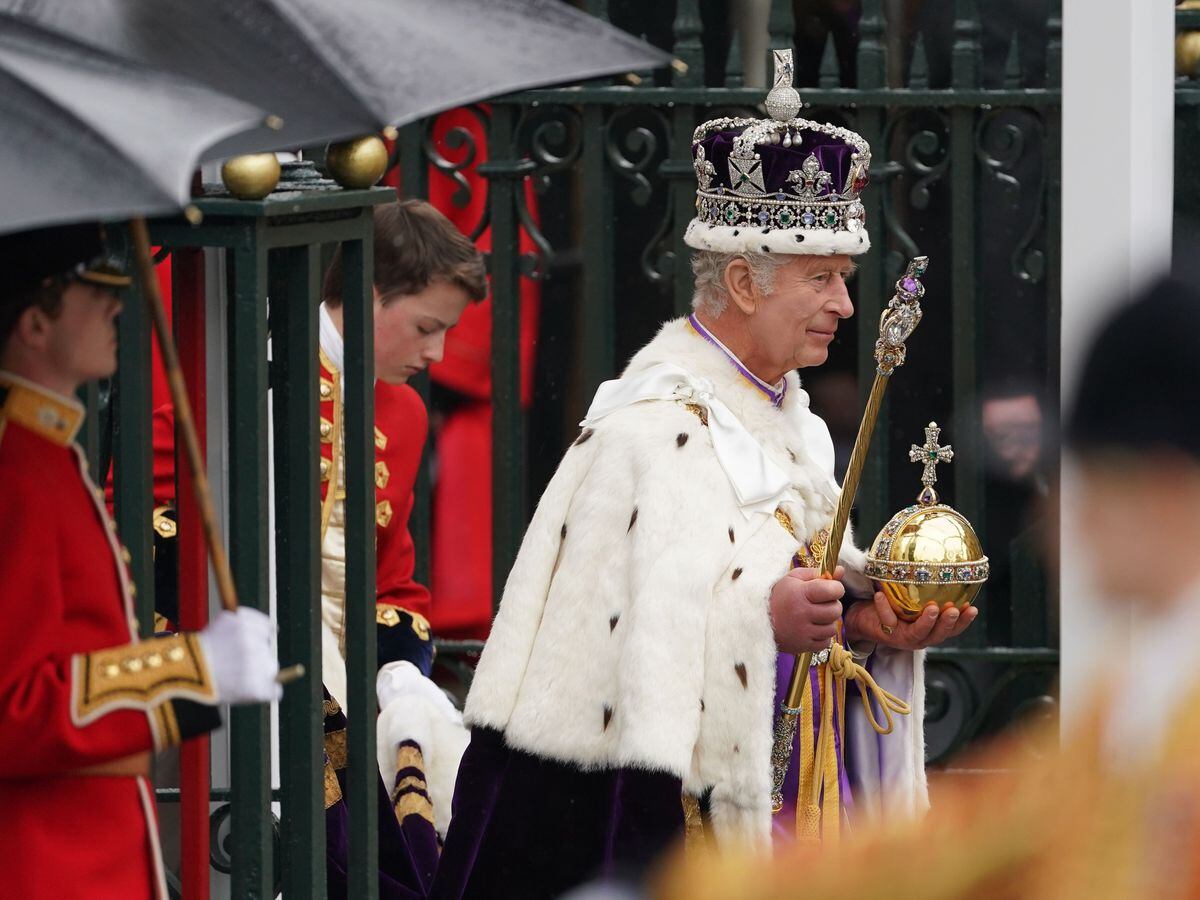 The King, wearing the Imperial State Crown, leaves Westminster Abbey (Joe Giddens/PA)