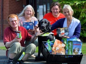 Tom Mosler and his guide dog Fin with Ruth Davies and Daniel Mason from Ludlow Food Bank and Frances Sproson, a Blue Cross manager
