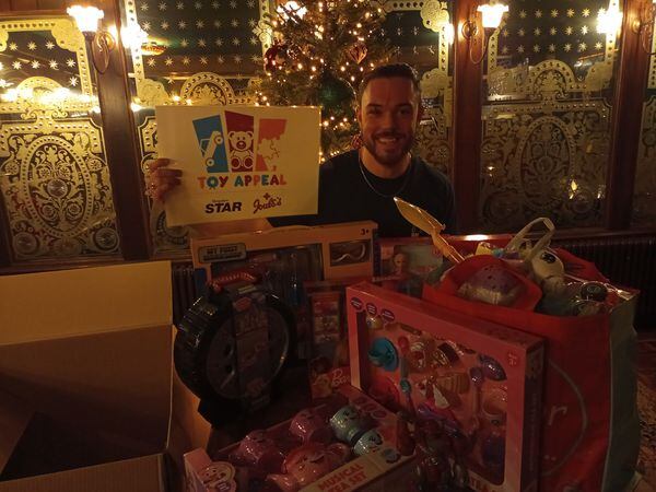 Waiter Callum Roberts of The White Horse in Shrewsbury with some of the toys donated to our Christmas Toy Appeal