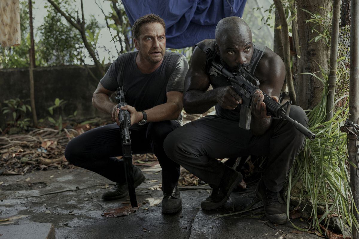 Gerard Butler as Brodie Torrance and Mike Colter as Louis Gaspare in Plane
