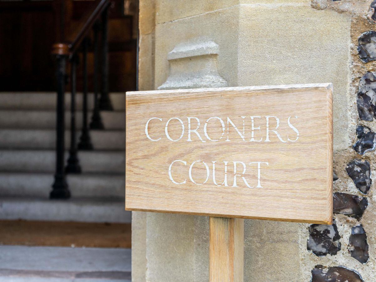 A wooden sign showing the words Coroners Court