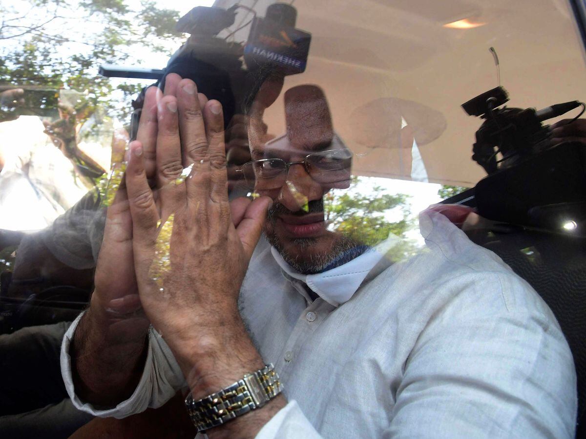 Bishop Franco Mulakkal greets the media as he leaves a court in Kottayam, India, in 2022