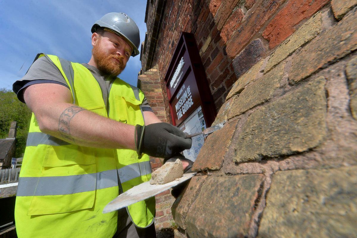 Sam Whyte from Cooper-Whyte Conservation who is working to match original mortar on sections of the listed building's brickwork.