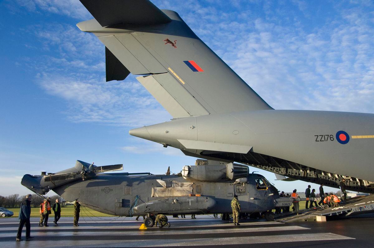 A giant Globemaster transport unloads this special ops helicopter at Cosford in December 2008