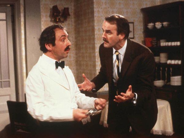 Andrew Sachs as Manuel and John Cleese as Basil in the BBCâs Fawlty Towers