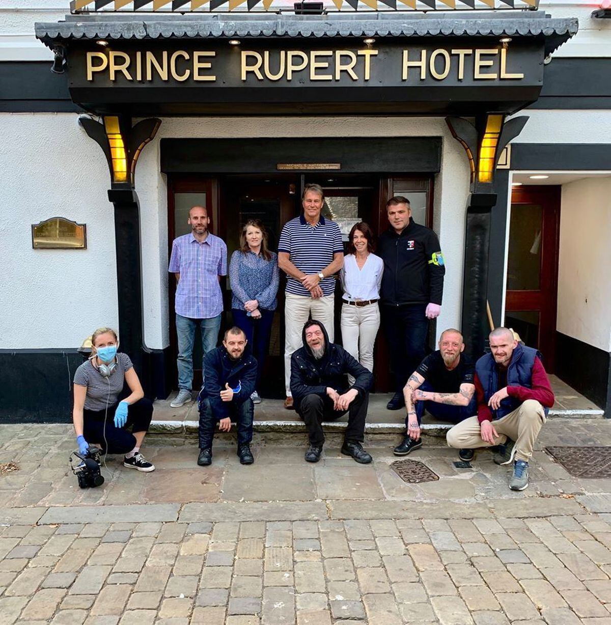 Mike Matthews, centre, with staff and homeless guests at the Prince Rupert Hotel