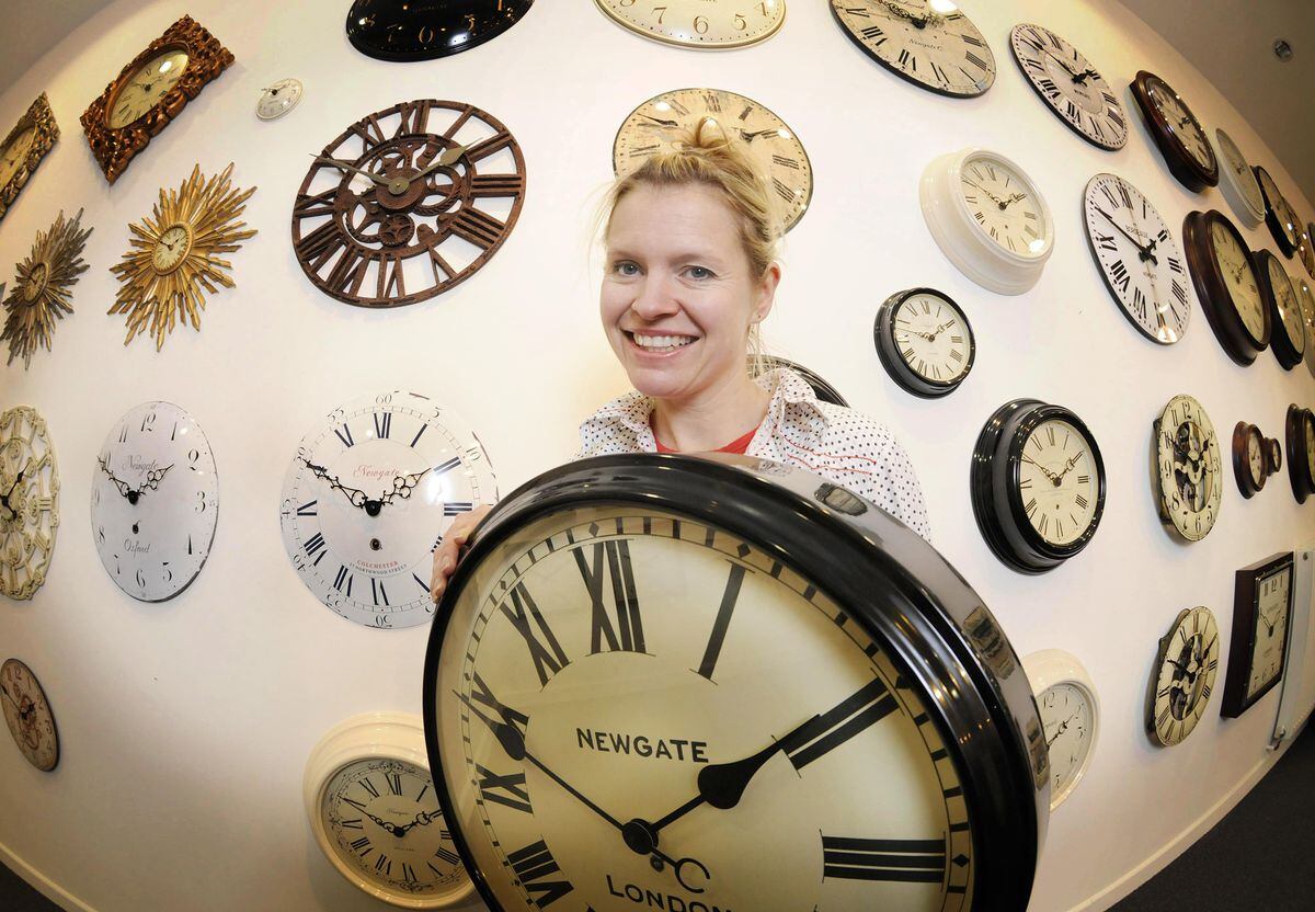 December 2000: Chloe Read shows off the many designs on offer at Newgate Clocks in Oswestry, after the company announced that some of its product production will return back to the United Kingdom from China