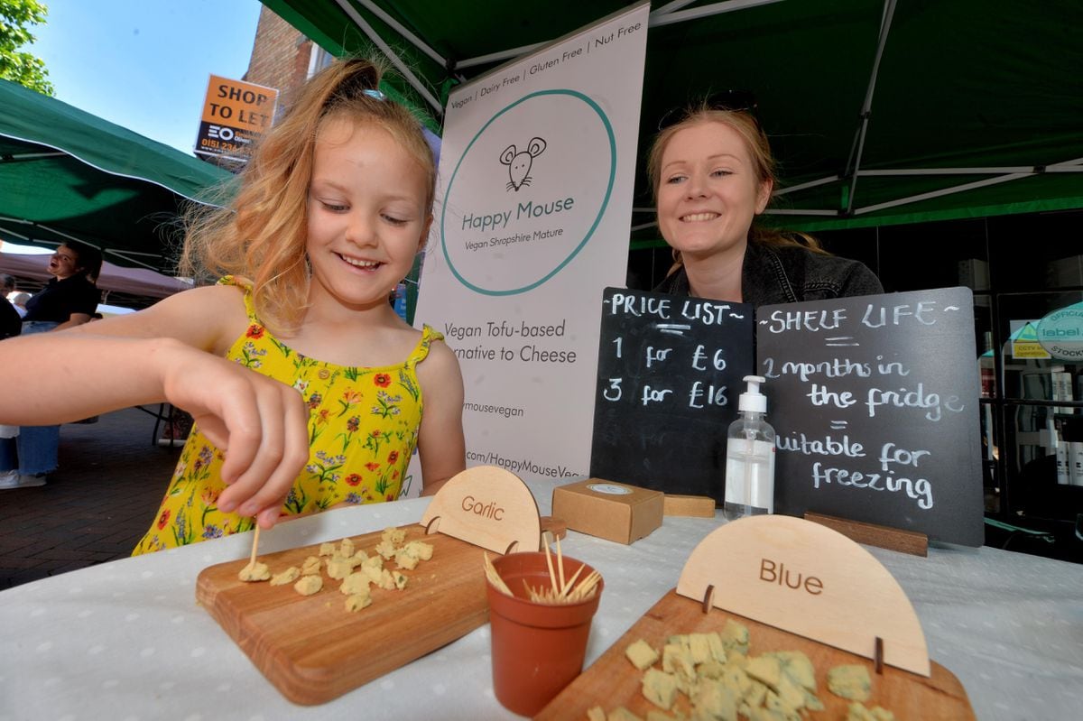 Delilah Morris, 6, tries a vegan treat watched by Sam Riley from Happy Mouse Vegan Shropshire Cheese 