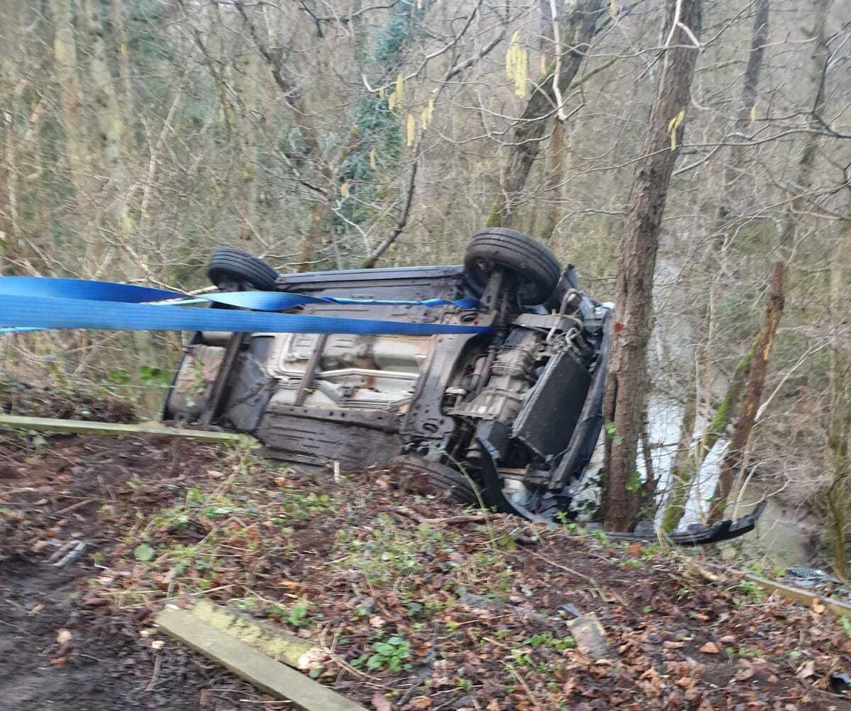 Three teenagers were trapped after the car they were in rolled over