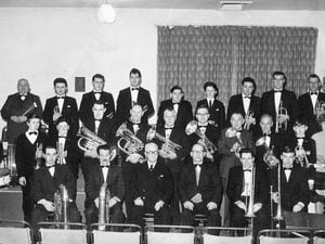 This picture of Dawley New Town Band in the 1960s was emailed in by Malcolm Westbrook, one of the band members. Ted Baldwin, the musical director, had blended young and experienced players to form a brass band for the new town in about 1963. According to the memory of another band member, those pictured are believed to be, back, from left, Albert Blakeway, Malcolm Westbrook, two unknowns, Martin Clews, two unknowns, Bill Hollyhead, and unknown. Middle, third along after the drummer, Bob Gittings, George Humphries, Harry Westbrook, unknown, Tom Lynton, two unknowns, and "Druscilla." Front, Danny Lane, two unknowns, Ted Baldwin, Ernie Howells and "Ted Baldwin's son."