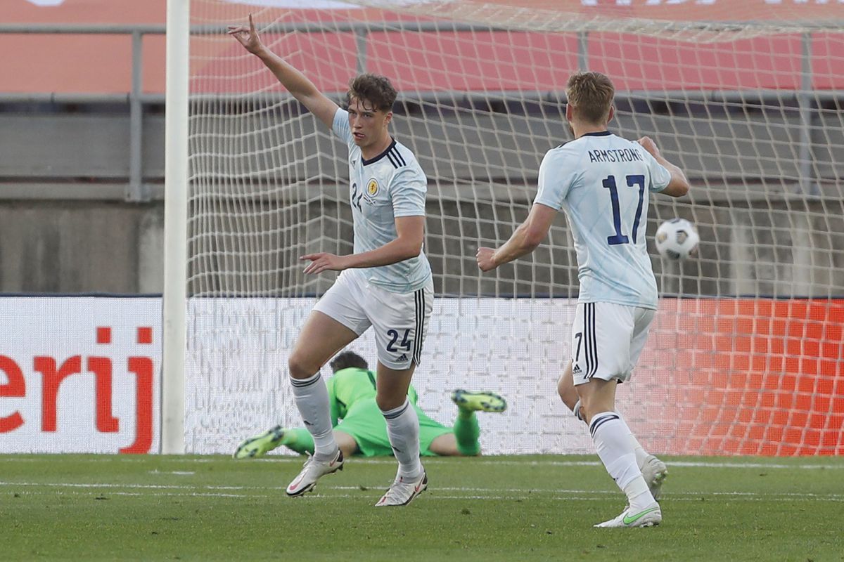 Scotland's Jack Hendry, left, celebrates after scoring his side's opening goal during the international friendly soccer match between the Netherlands and Scotland at the Algarve stadium outside Faro, Portugal, Wednesday June 2, 2021. (AP Photo/Miguel Morenatti).