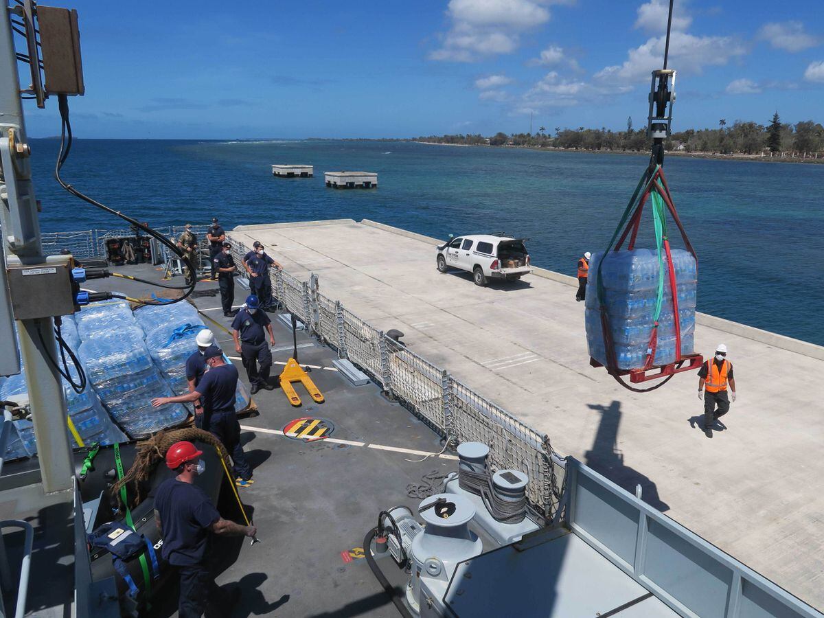 HMS Spey unloading supplies in Tonga