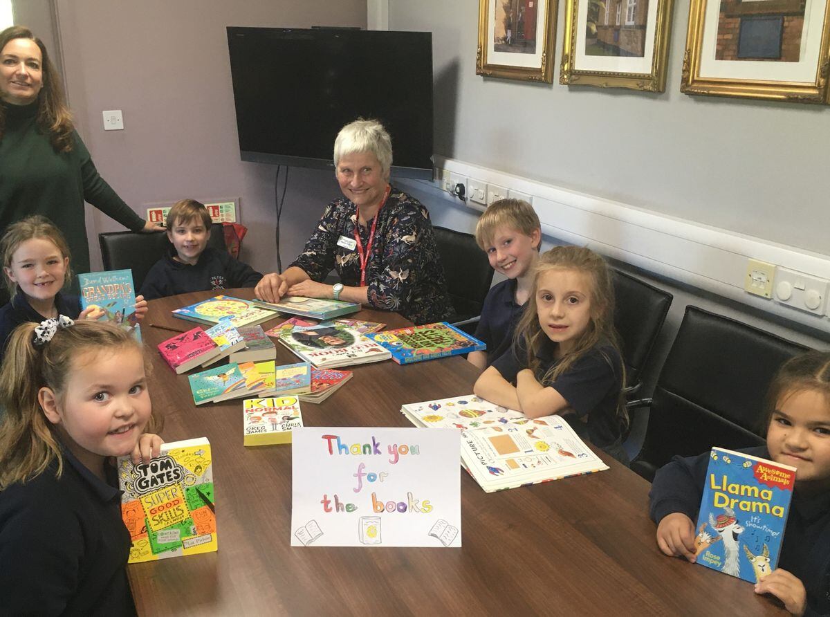  Young readers Mollie, Rosie, Henry, Lorcan, Hope and Hermione from St Peter's CE Primary School Edgmond enjoying the books with school Literacy Lead Kelly Roman and Newport Rotary Lite President Margie Haslop