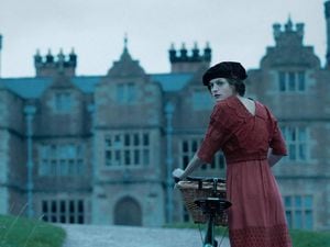 Emma Corrin as Lady Chatterley with Brynkinallt Hall in the background