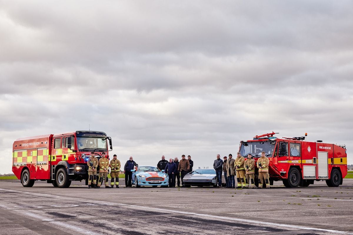 Royal Naval fire fighters, Royal Naval staff, and the CMC team pose with Bulldog and an Aston Martin DB9 used as chase car on the day. Photo: Richard Johnson