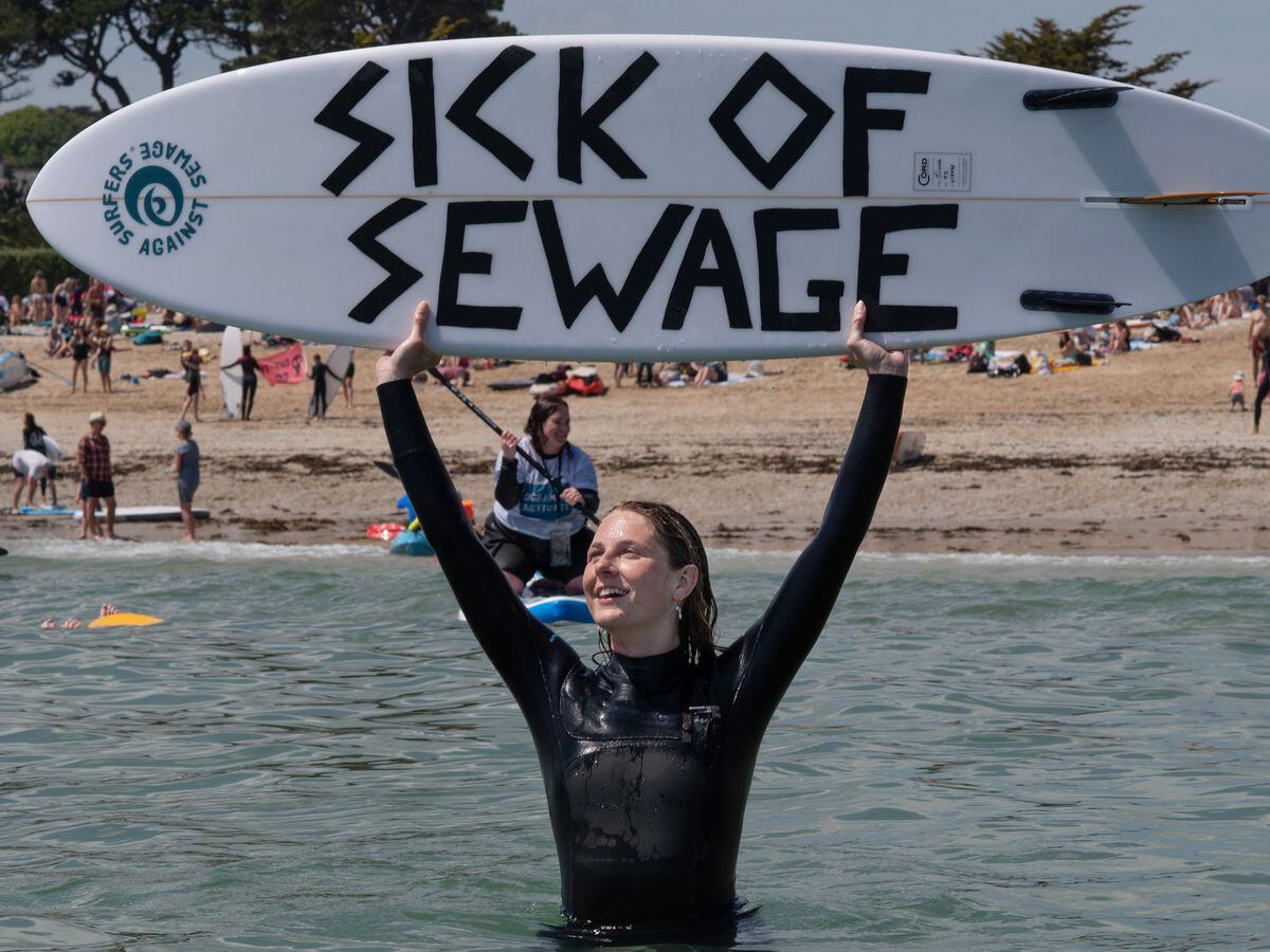 Anti-sewage activist with a surfboard