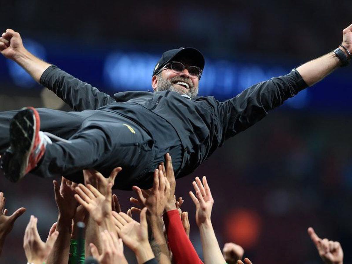 Liverpool players lift manager Jurgen Klopp after the final whistle of the Champions League final