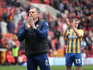Steve Cotterill the head coach / manager of Shrewsbury Town applauds the travelling Shrewsbury Town fans.