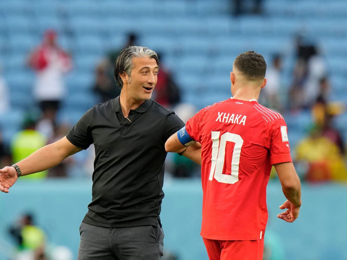 Switzerland head coach Murat Yakin, left, celebrates victory
