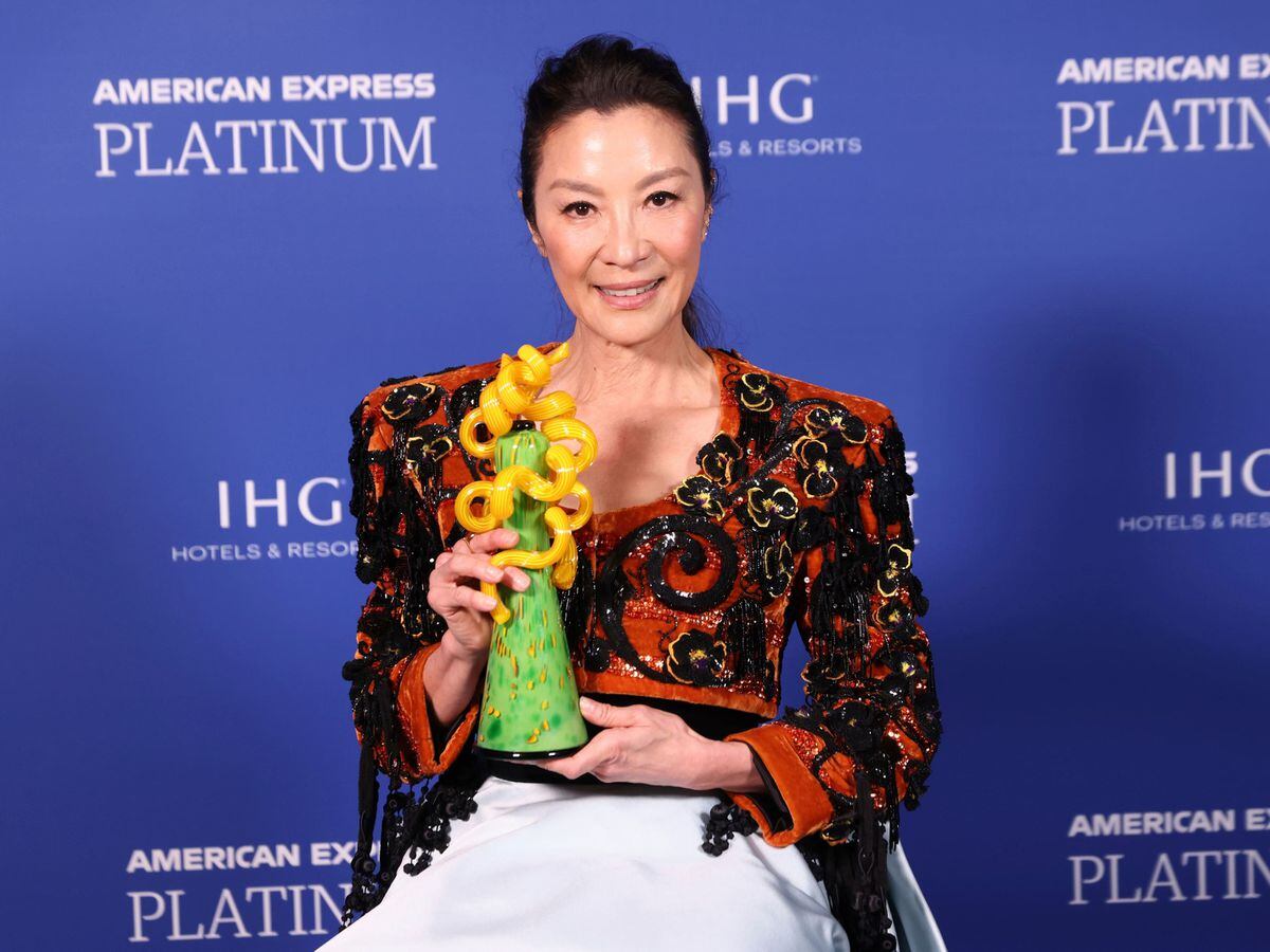 Michelle Yeoh poses backstage with the international star award by an actress for Everything Everywhere All At Once at the 34th annual Palm Springs International Film Festival Awards Gala on Thursday January 5 2023, in Palm Springs, California
