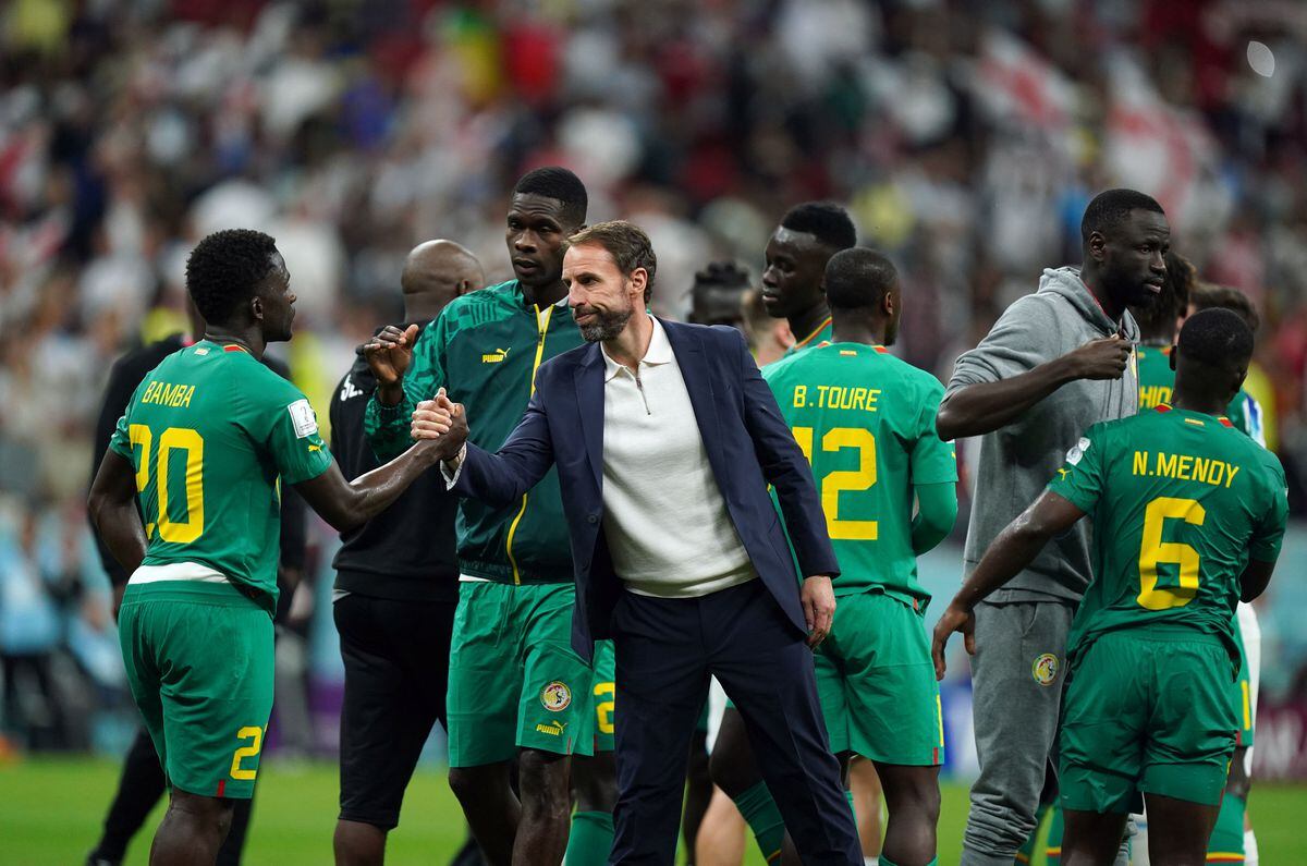               England manager Gareth Southgate with Senegal's Bamba Dieng 