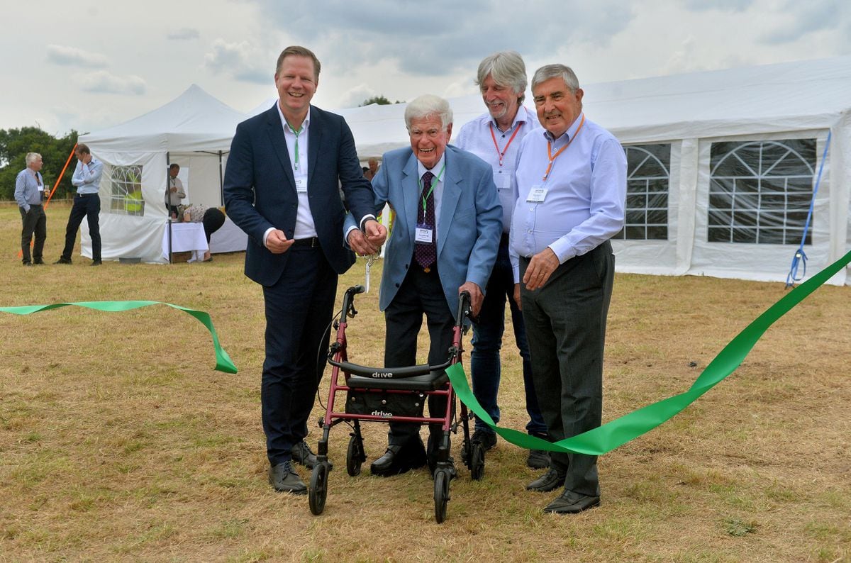Aled Griffiths OBE cuts a ribbon along with from Ulf Meyer, from Big Dutchman International GmbH, Elwyn Griffiths and Denis Brosnan, from BHSL Group