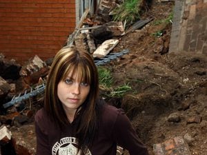 Serena Hipkiss with what remained of her garden, following the collapse of a retaining wall