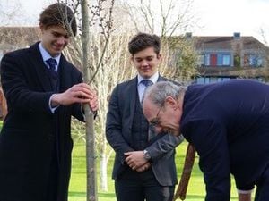 Deputy Lieutenant of Shropshire and Shrewsbury School Estates Governor David Stacey plants an Elm as members of the Eco Committee look on. 