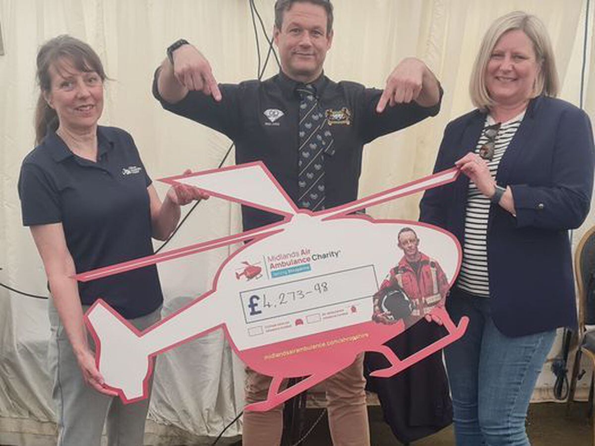 Phil Jeffries,(centre, and Kirsty Brooks, right, present the cheque to Midlands Air Ambulance fundraising manager Maria Jones 