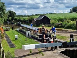 Holiday boaters leaving Tyrley top lock on the Shropshire Union Canal near Market Drayton