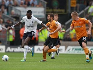 Tottenham Hotspur's Emmanuel Adebayor (left) in action against Wolverhampton Wanderers' Roger Johnson (centre) and Jamie O'Hara (right) during the Barclays Premier League match at Molineux Stadium, Wolverhampton. PRESS ASSOCIATION Photo. Picture date: Saturday September 10, 2011. See PA Story: SOCCER Wolves. Photo credit should read: Nick Potts/PA Wire. RESTRICTIONS. EDITORIAL USE ONLY. No use with unauthorised audio, video, data, fixture lists, club/league logos or 'live' services. Online in-match use limited to 45 images, no video emulation. No use in betting, games or single club/league/player publications. 