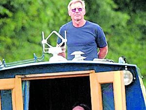 Harrison Ford at the helm of a narrowboat on the picturesque Llangollen Canal in Shropshire, in 2004