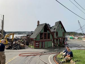 Firefighters after battling a fire that destroyed the Port Clyde General Store and other waterfront businesses in Port Clyde, Maine