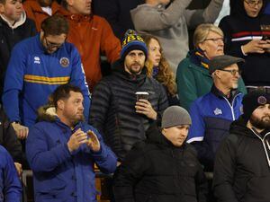 Former Shrewsbury Town player David Edwards watches the game in the safe standing area.