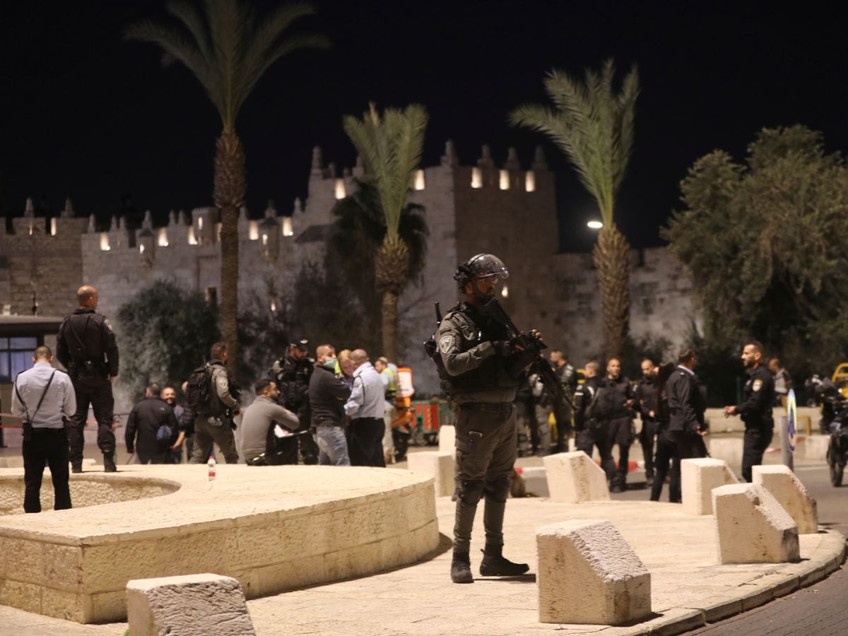 An Israeli policeman stands guard near Damascus Gate to the Old City of Jerusalem (Mahmoud Illean/AP)