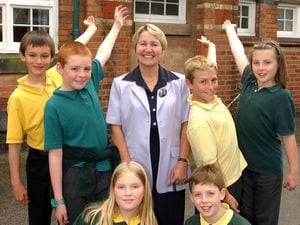Head Marianne Phillips and pupils outside Newport C of E Junior School in 2002.