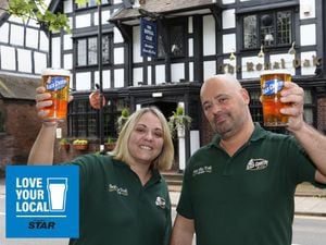 Landlord Jonathan Francis Reynolds and Kirsty Sumner raise a glass to the King at The Royal Oak pub